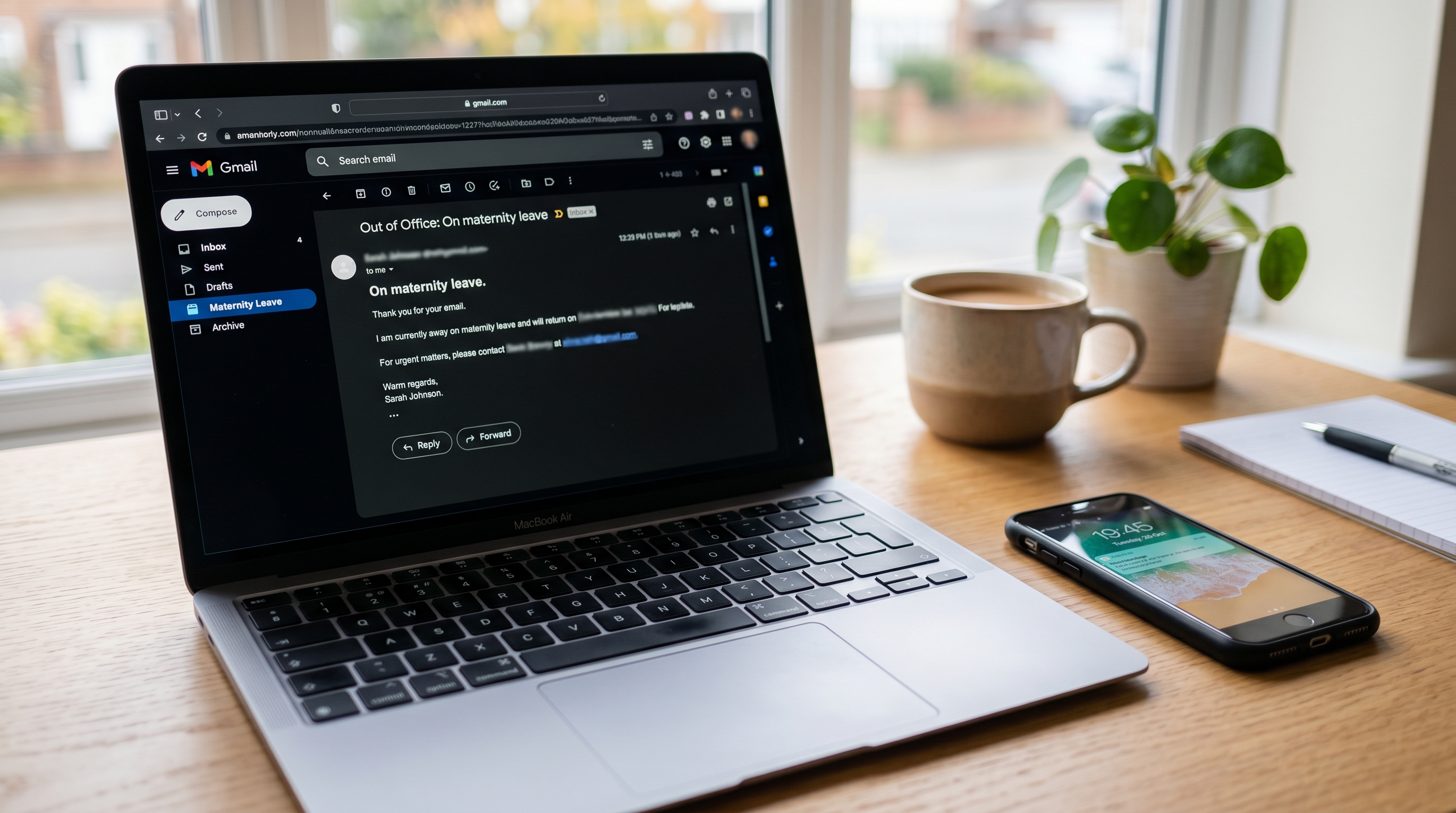 Laptop showing a maternity leave out of office auto-reply email in an inbox