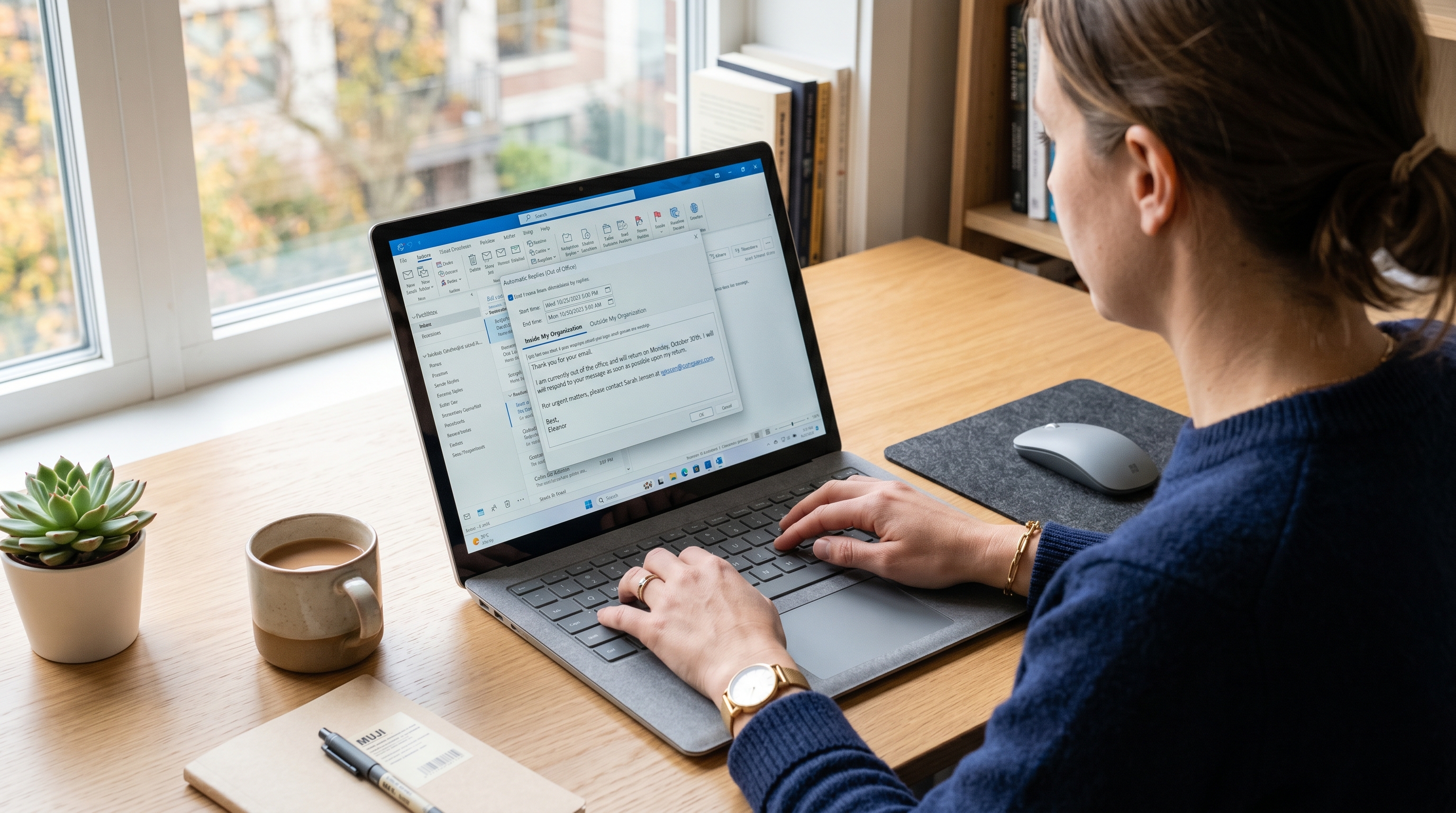 Hands typing an Automatic Replies note in the Outlook desktop out of office settings dialog
