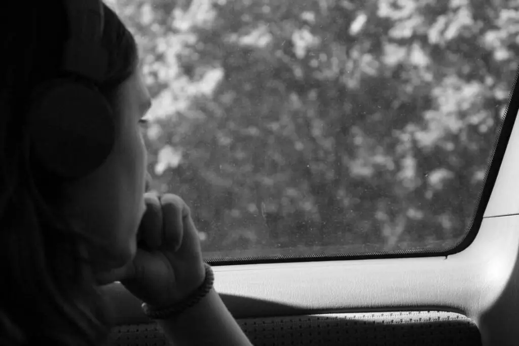 The Importance of Intrapersonal Communication and How to Improve Your Skills 4 Grayscale photo of a woman inside a car practicing intrapersonal communication.