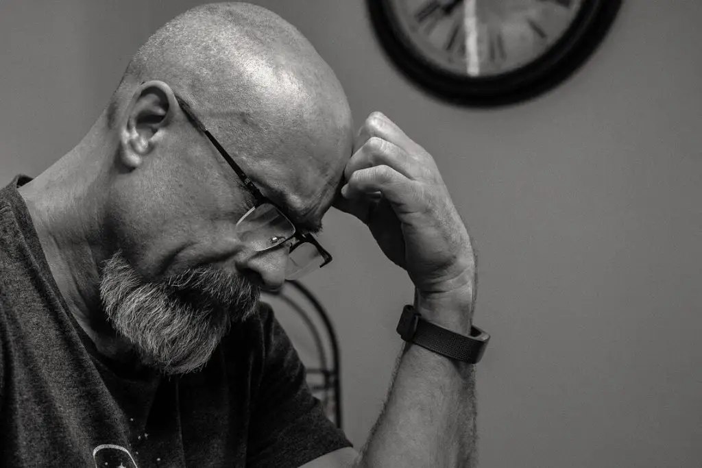 The Importance of Intrapersonal Communication and How to Improve Your Skills 5 Image of a Man Thinking in Front of Analog Wall Clock, ways to Improve Intrapersonal Communication