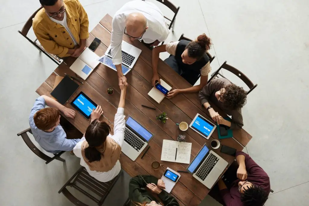 A group of people sitting at a table. Management team. 