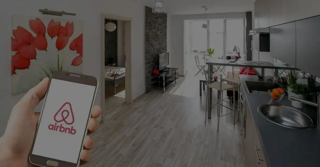 A picture containing a telephone with an Airbnb app and an indoor house. Disintermediation 