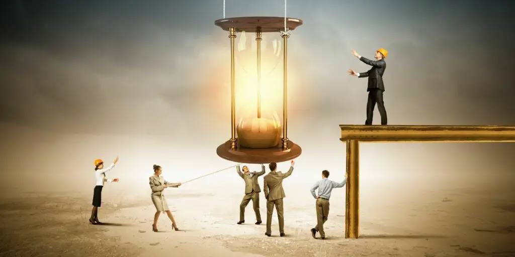 Conceptual image of businesspeople looking at sandglass 