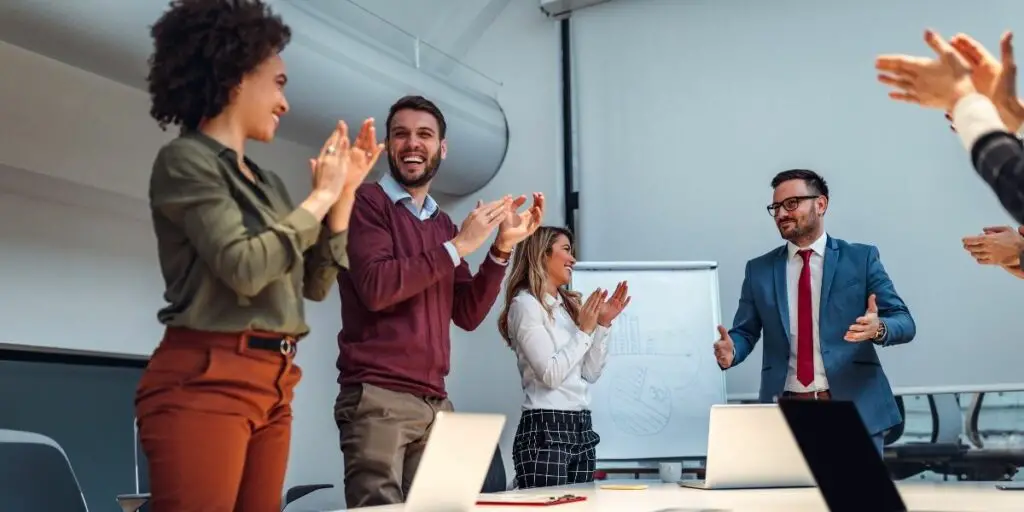 shot of a group of coworkers applauding after a successful presentation in a boardroom