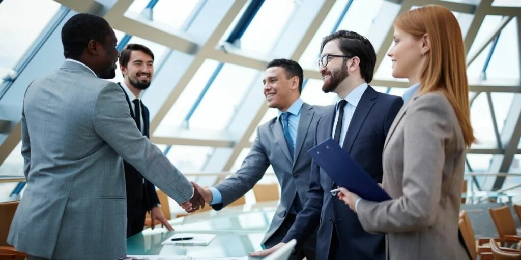 15 Examples of Interpersonal Skills That Will Help You Grow 4 two businessmen handshaking after striking grand deal