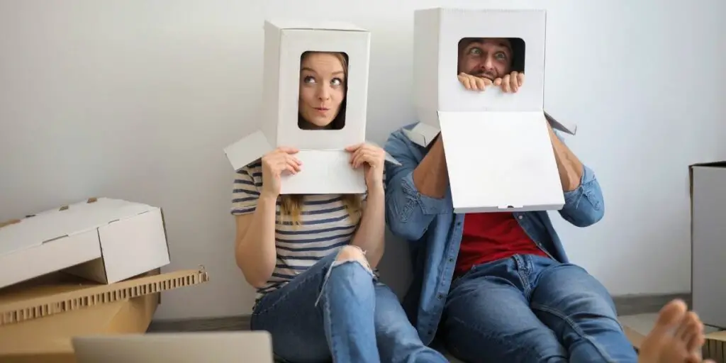 funny couple with heads in boxes