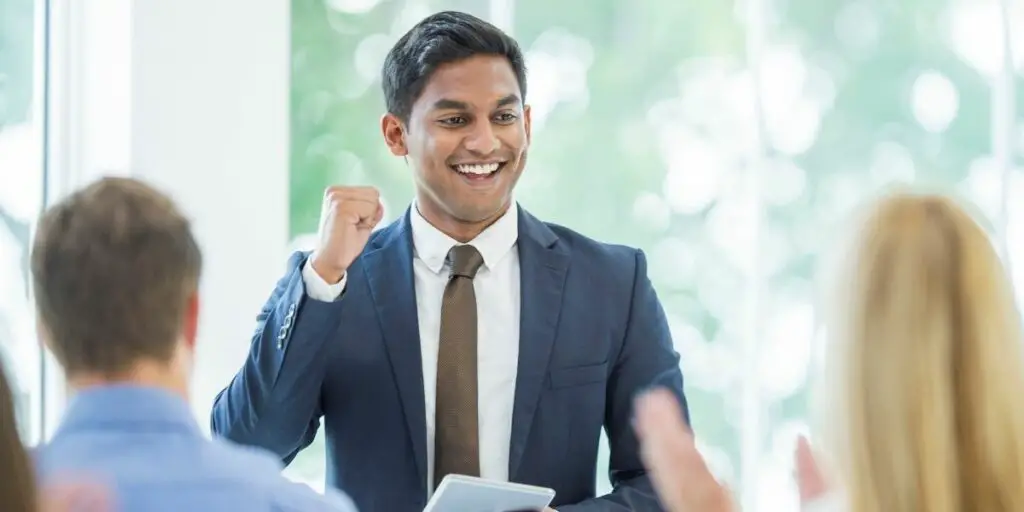 A multi-ethnic group of young business people is in a business presentation. 