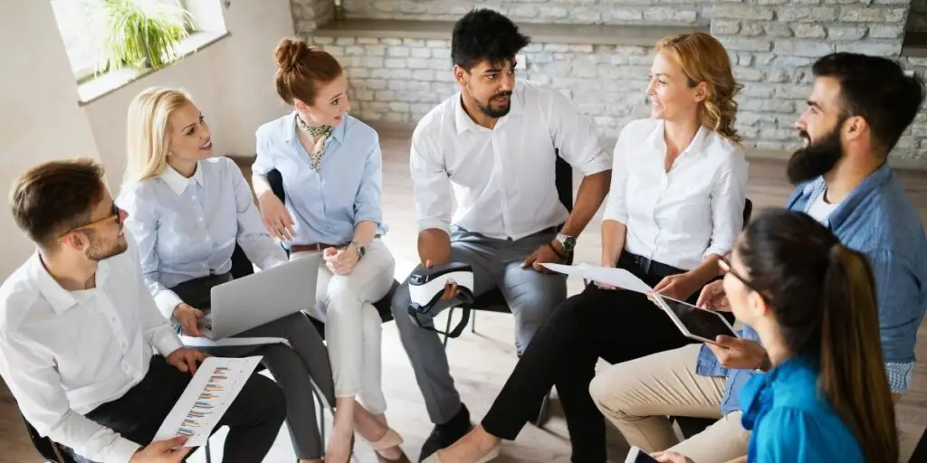 Successful, happy group of workers having a meeting with their transformational leader.