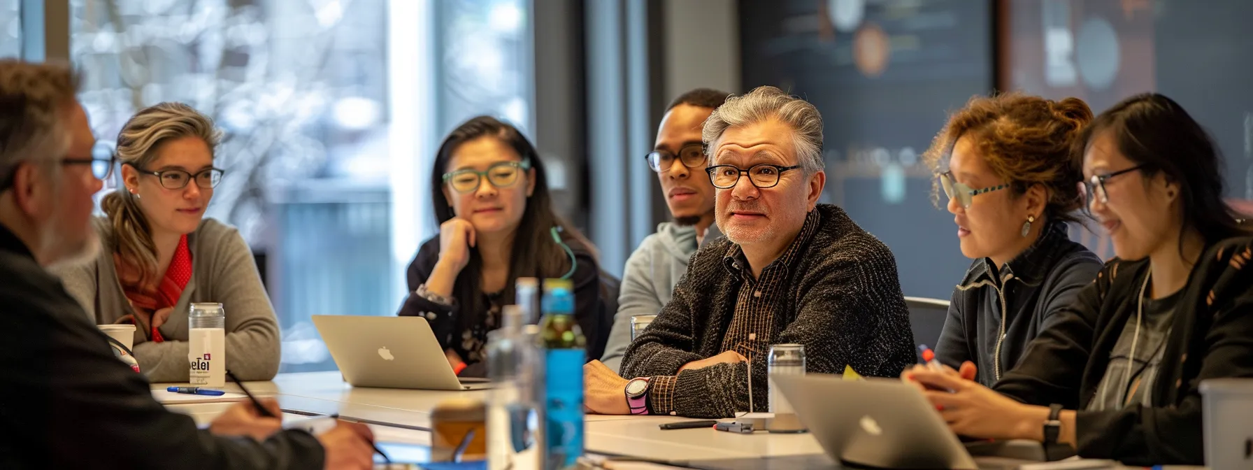 a diverse group of professionals working together in a meeting room, engaged in active listening and sharing ideas for innovative project management strategies.