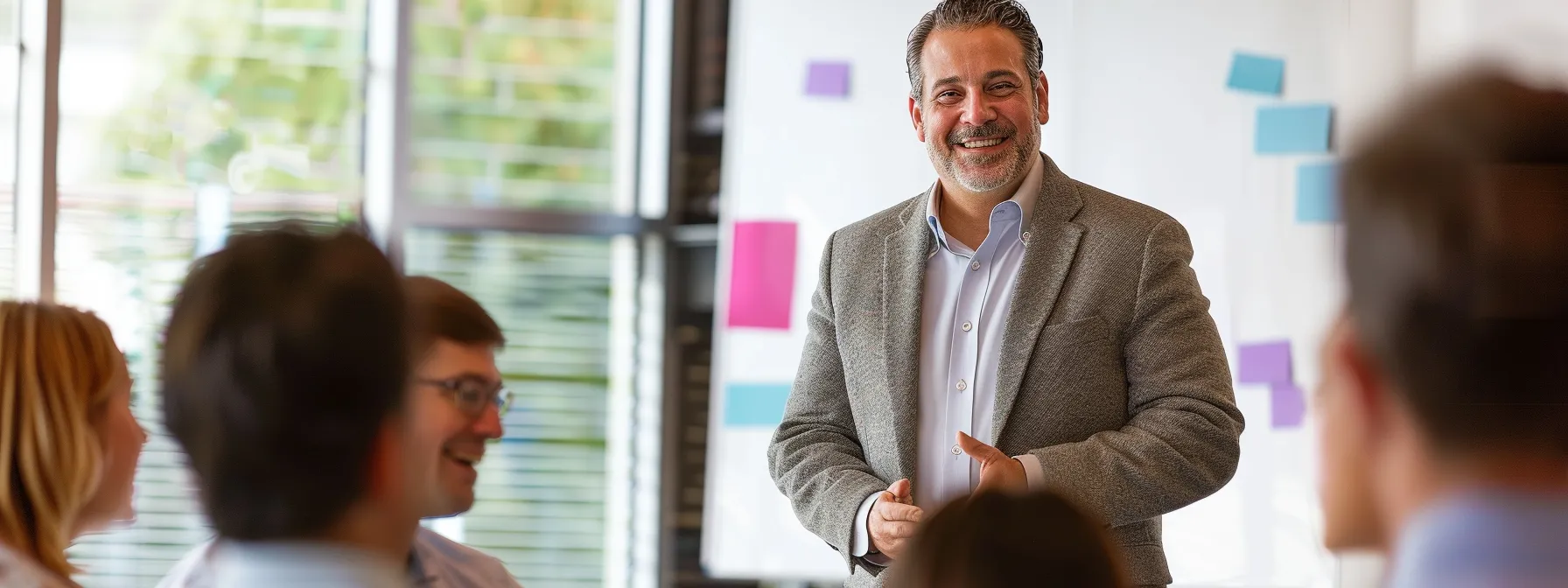 a charismatic leader, standing confidently with a clear vision board behind them, engaging with a diverse group of followers in a meeting room.