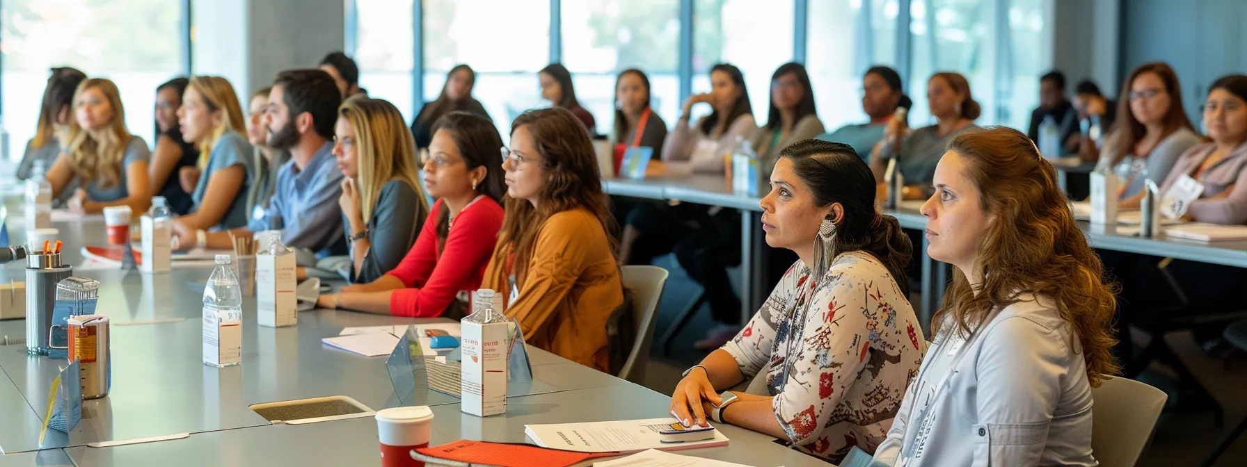 a diverse group of employees engaged in a training session, actively participating and sharing insights to foster a supportive workplace environment.