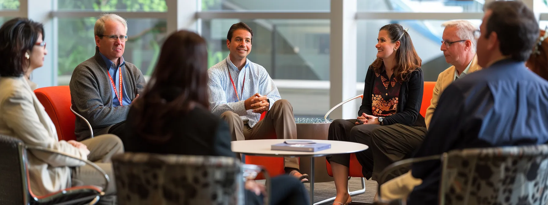 a diverse group of professionals engaged in a lively discussion, showcasing strong communication and interpersonal skills in action.