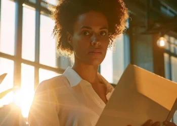 a stern-faced employee confidently presenting documents in a well-lit office setting, ready to legally refute false accusations at work.