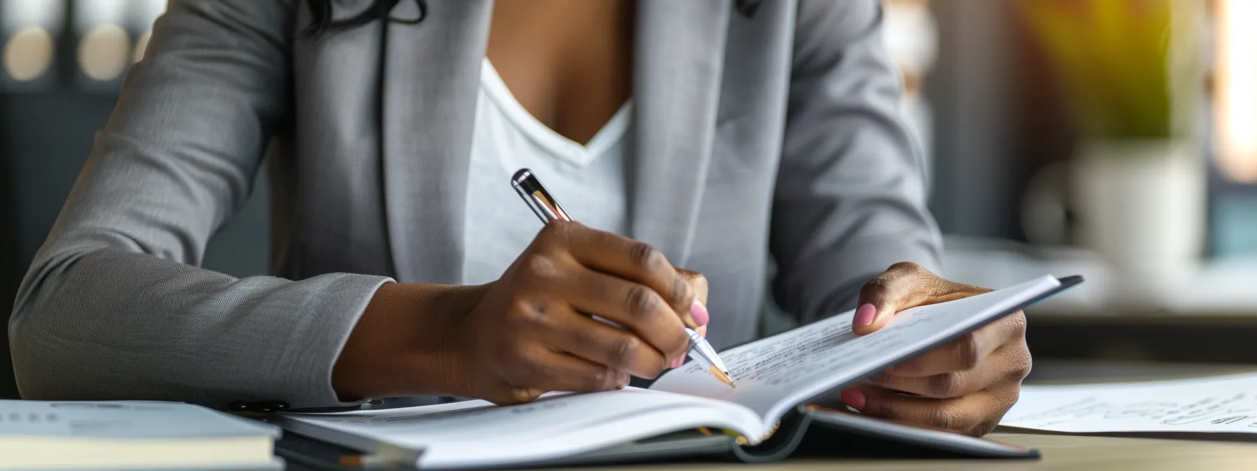 a person calmly documenting interactions with a notebook and pen in an office setting, showing diligence and professionalism when faced with false accusations at work.