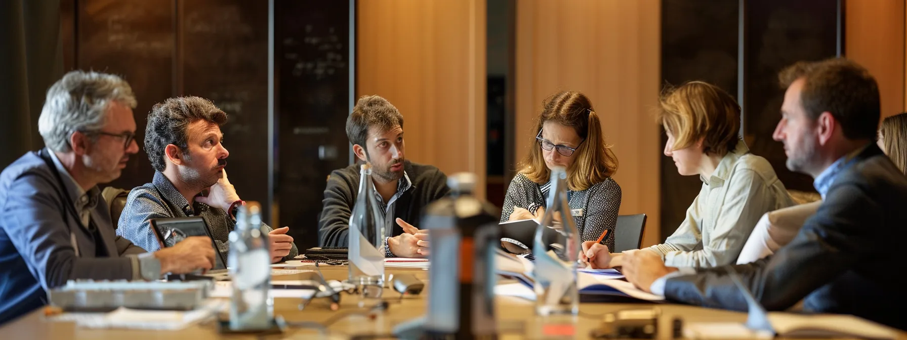 a team sitting around a table, engaging in a deep discussion with thoughtful expressions, while a leader takes notes and listens attentively.