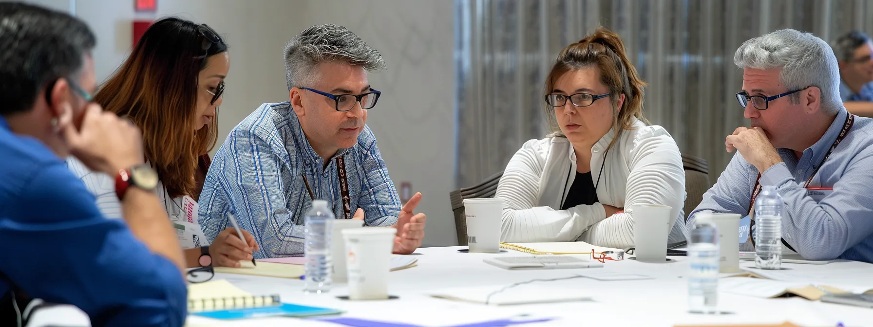 a diverse group of professionals sitting around a table, engaged in a lively discussion, with notes and charts scattered around, showcasing collaborative negotiation techniques in action.